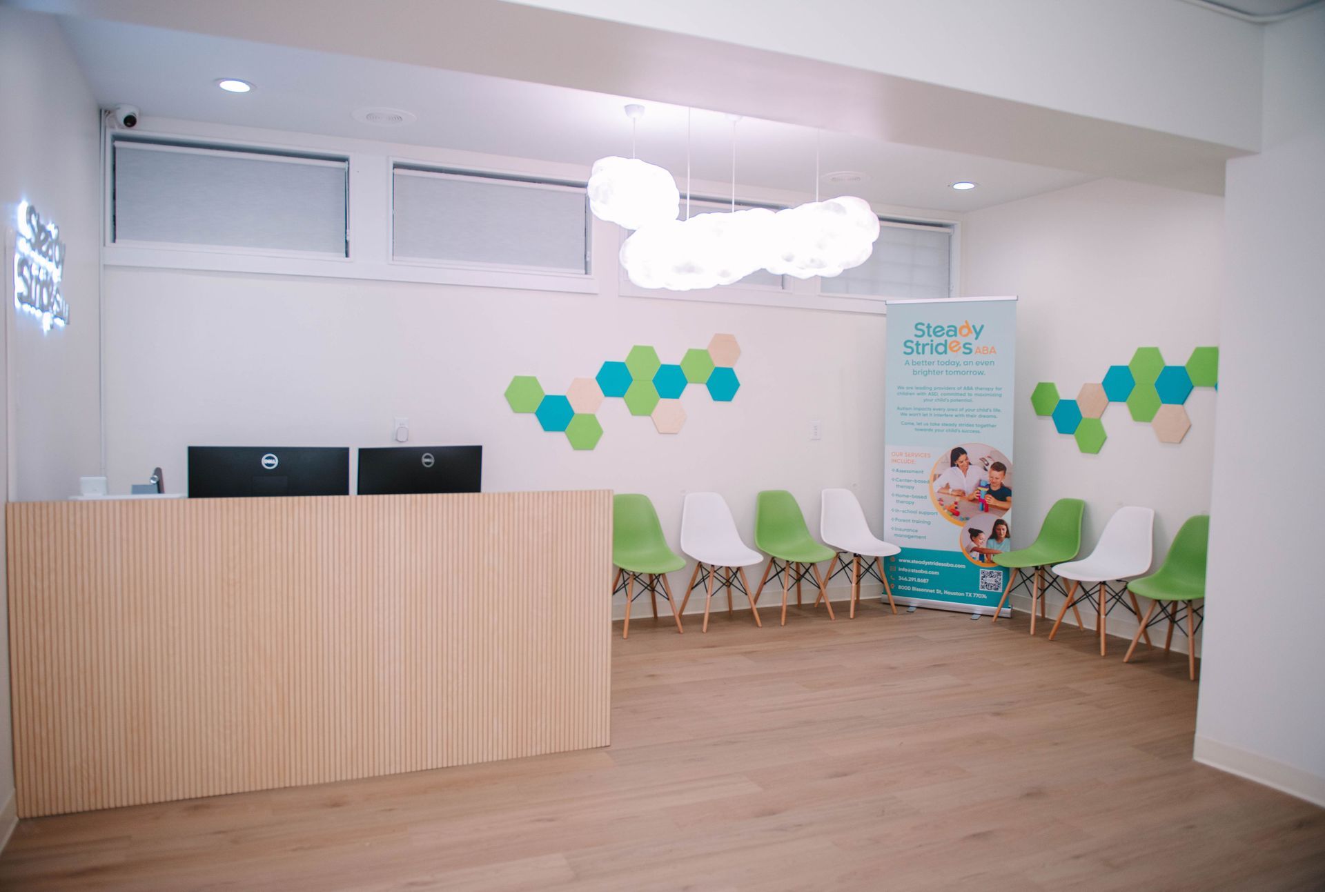 A waiting room with a desk and chairs in a hospital.