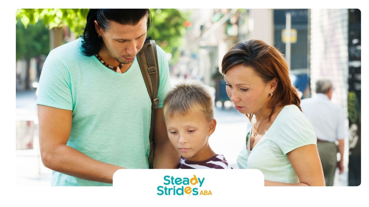 Family reviewing a map together outdoors, symbolizing guidance and navigating autism services