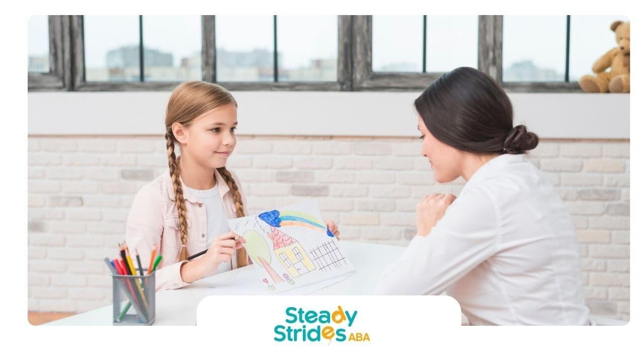 Autistic girl showing her colorful drawing to a therapist or teacher during a supportive counseling