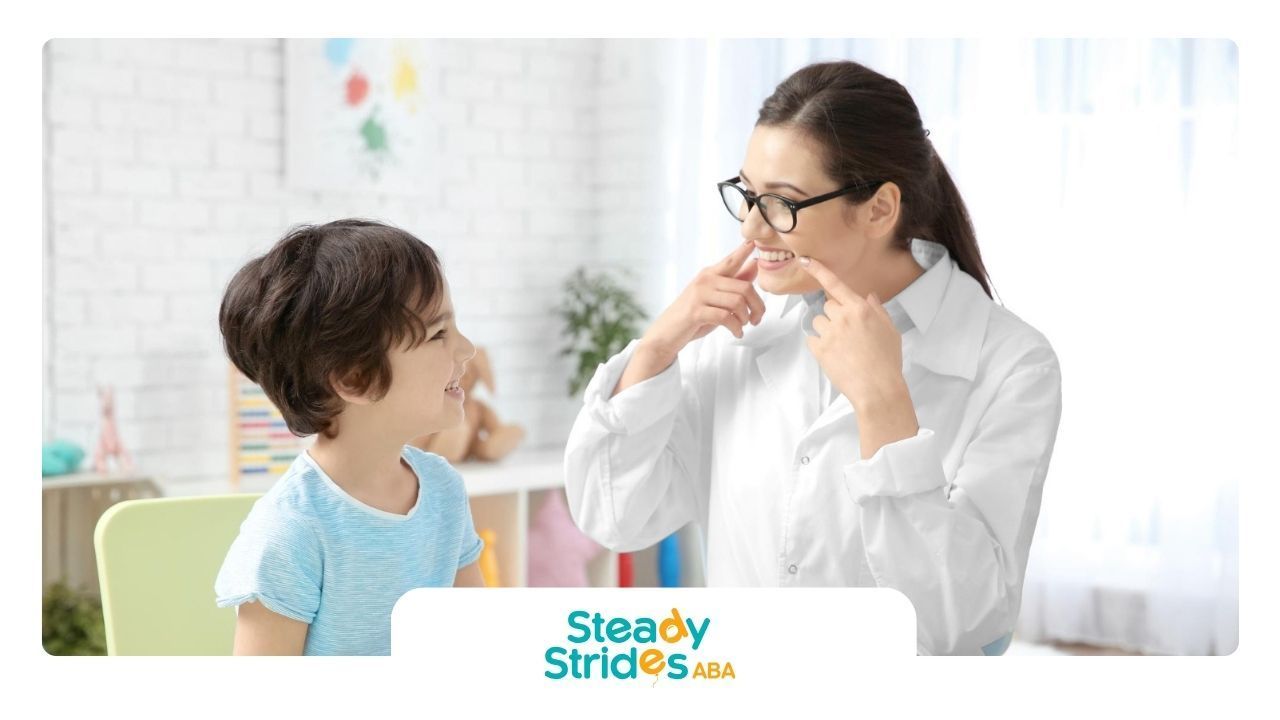 A BCBA is talking to a young boy.