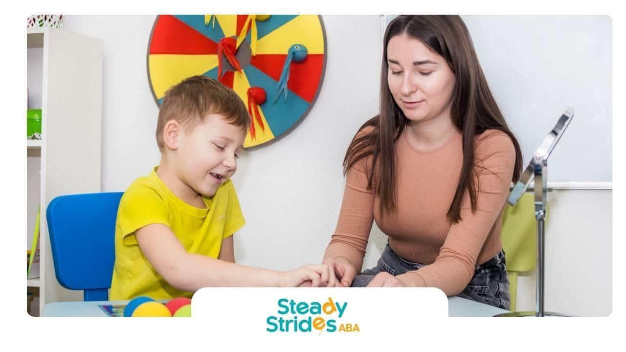 Therapist or caregiver playing a board game with an autistic child, supporting structured play.
