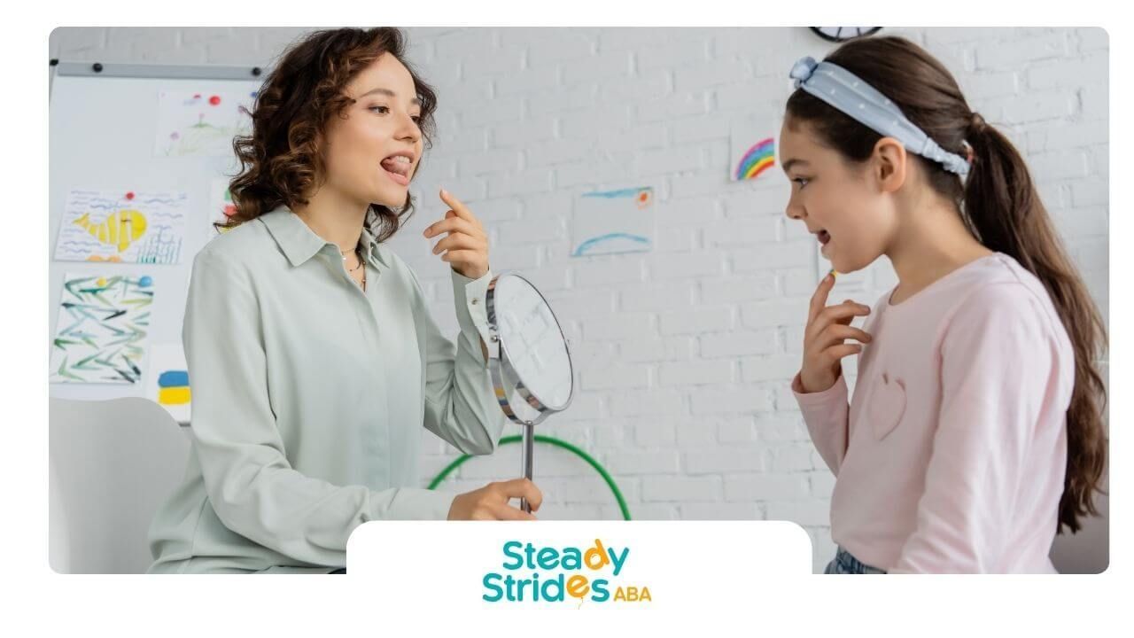 Speech therapist uses a mirror to help a autistic girl practice mouth movements and pronunciation