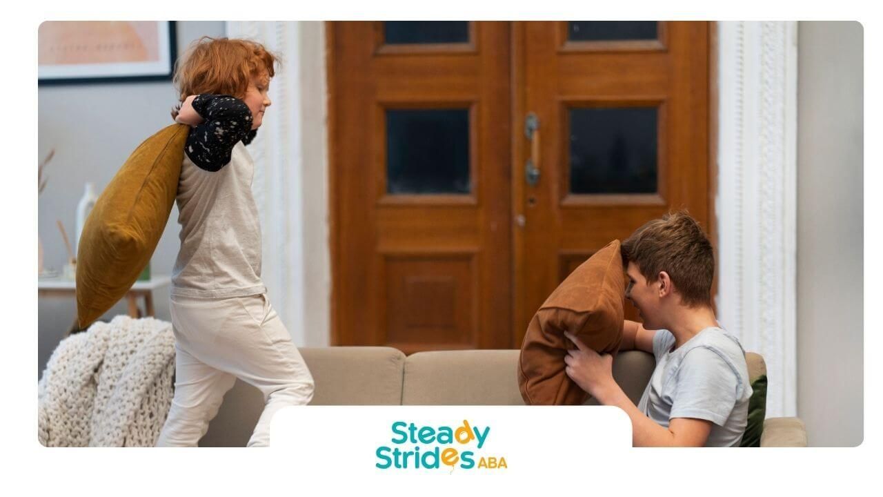 Two autistic kids playfully engage in a pillow fight on a couch at home, showing active play