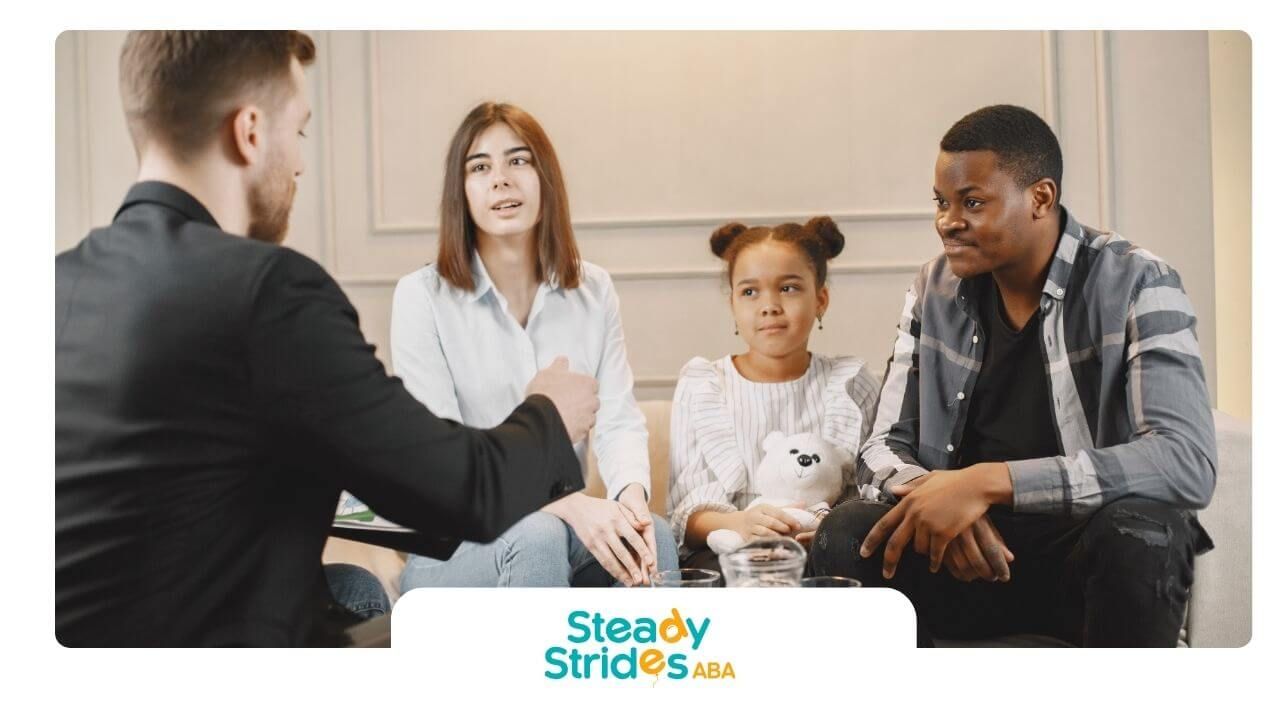  Therapist meets with parents and autistic girl in office, discussing support plans and progress