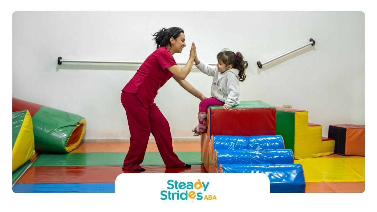 A woman and a little girl are giving each other a high five.