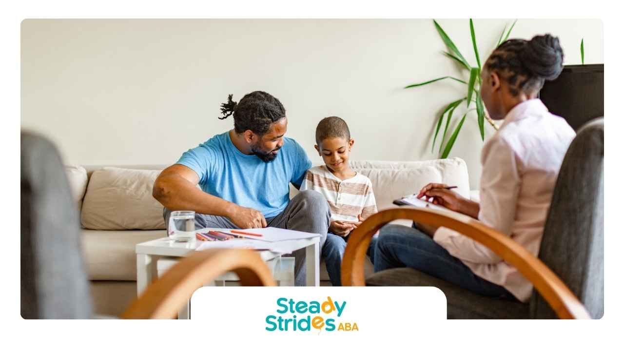 A man and a child are sitting on a couch talking to a woman.