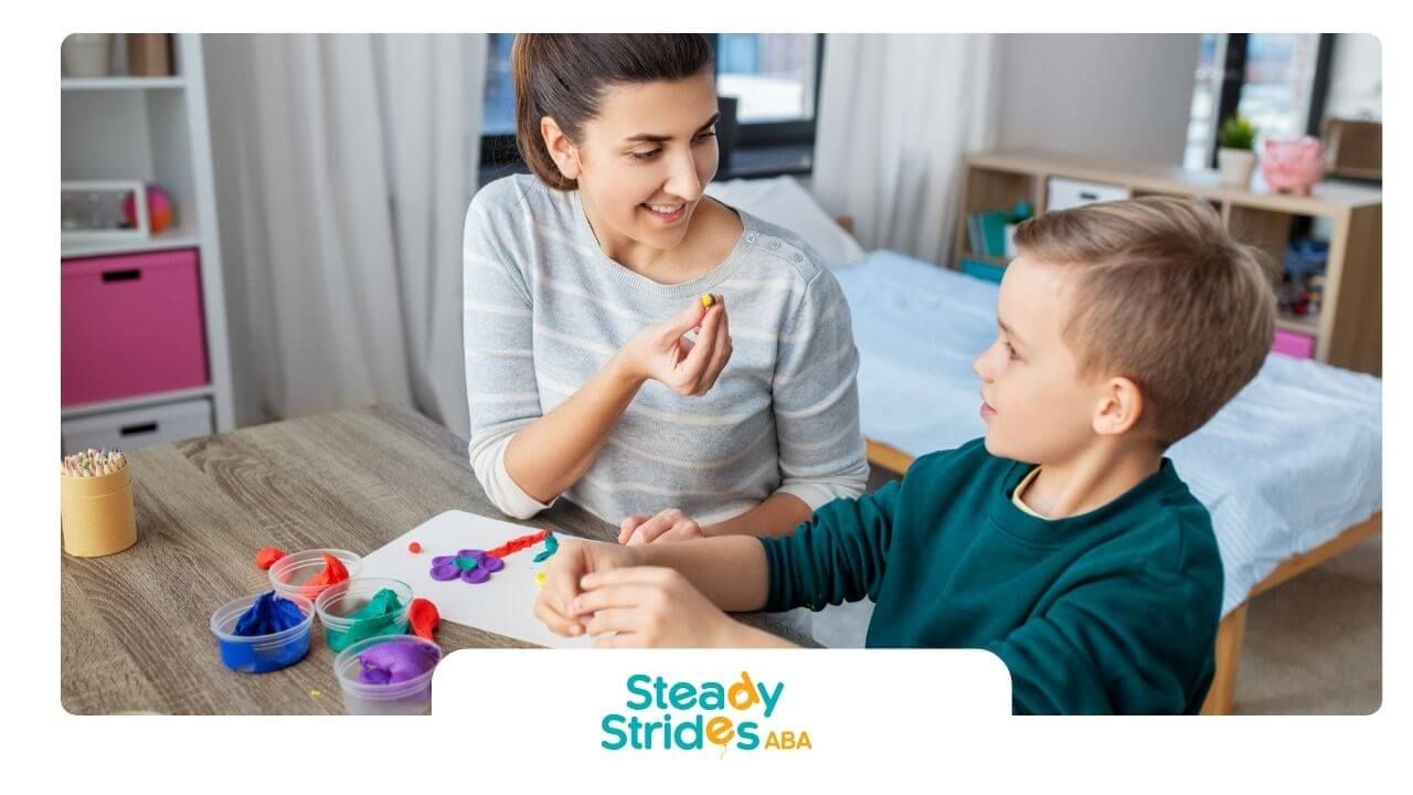 Therapist engaging autistic boy in creative play with colorful modeling clay at home therapy session