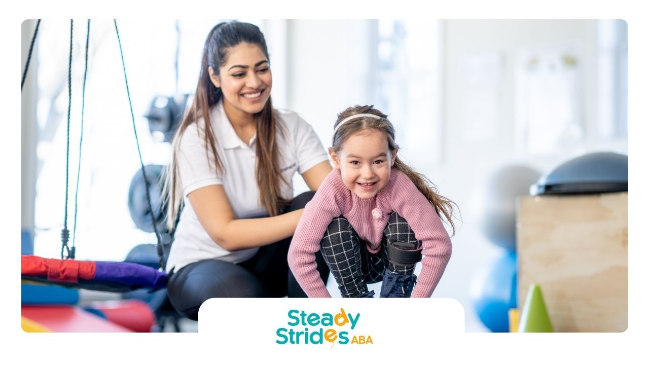 A woman is sitting next to a little girl in a gym.