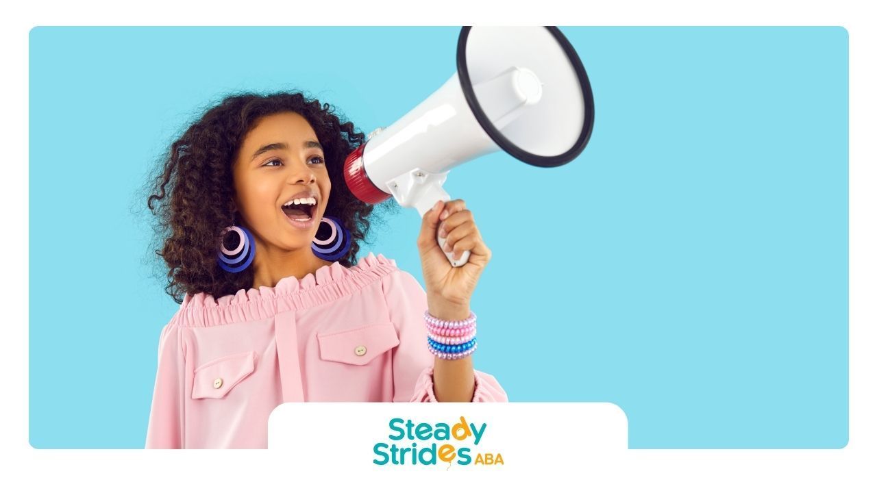 A young girl is holding a megaphone in her hand.