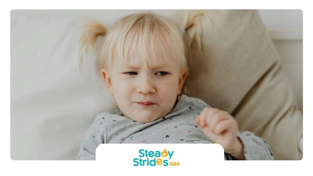 Blonde autistic toddler with pigtails showing a confused or unhappy facial expression at home in TX.