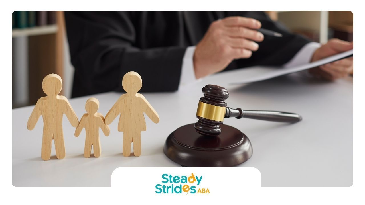 A judge is sitting at a table with a wooden family and a gavel.