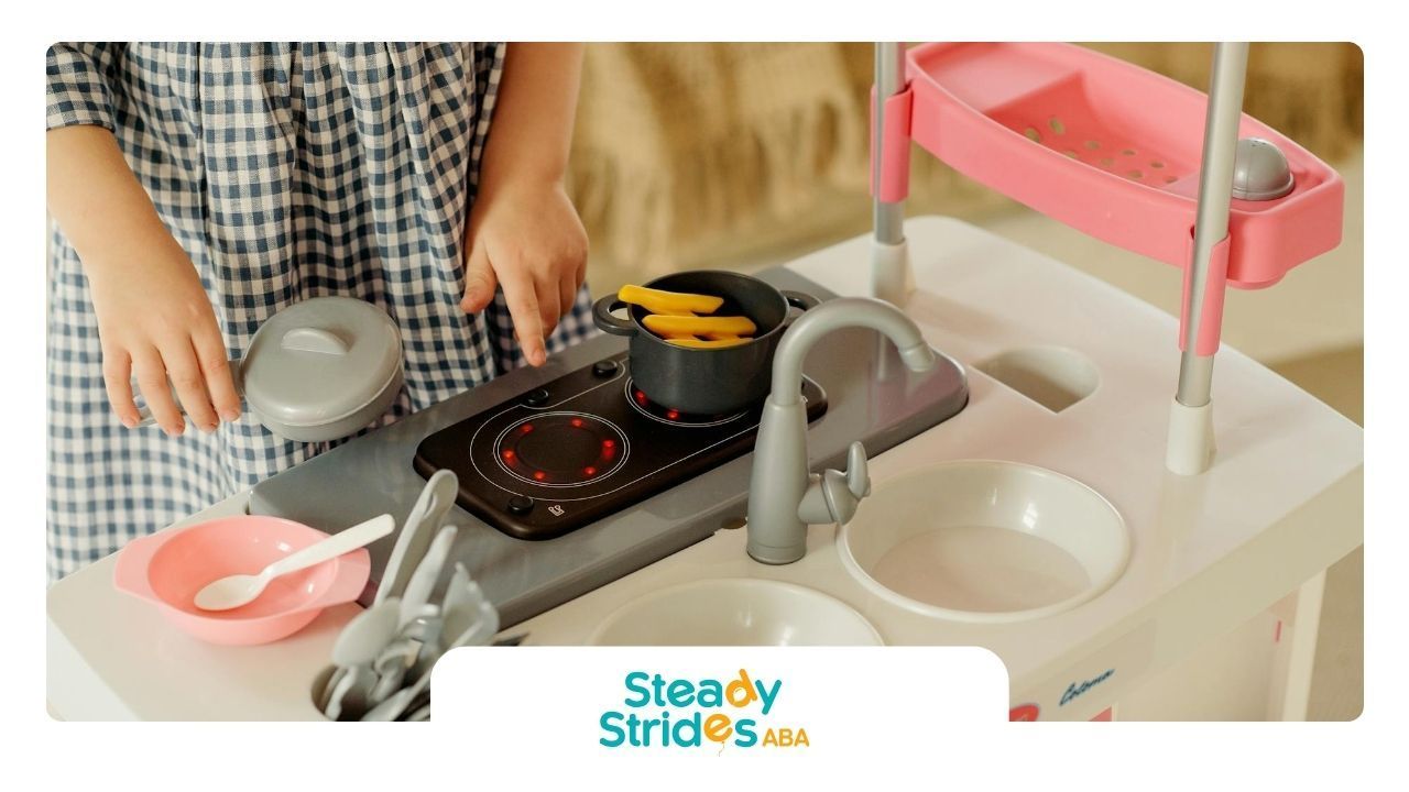 An autistic child playing with toy kitchen set and utensils during pediatric ABA therapy in Texas.