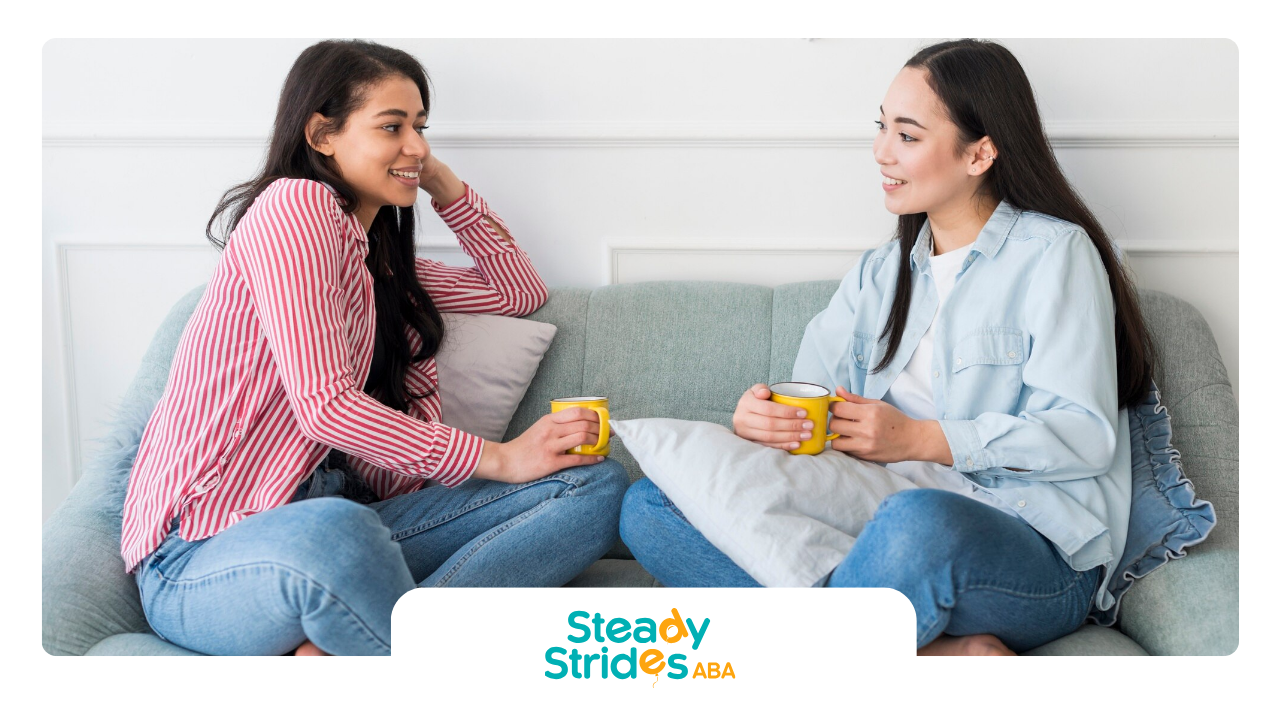 A teenager and an RBT are sitting on a couch, talking to each other.