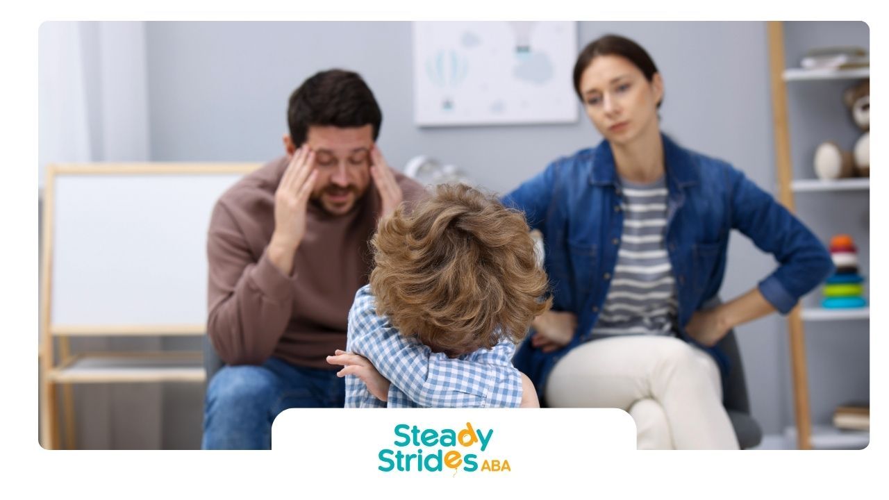 Child with parents, faces hidden. Parents look stressed in a counseling setting, with a whiteboard in the background.