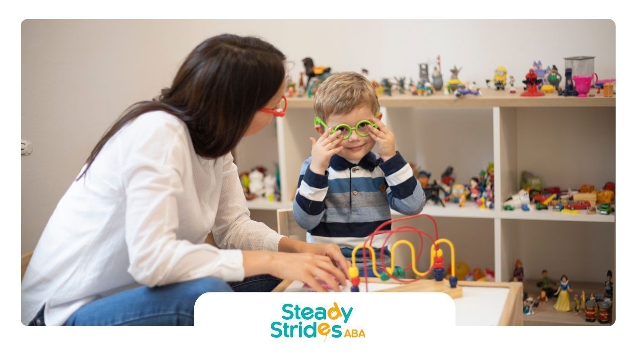 A woman is talking to a young boy who is wearing glasses.
