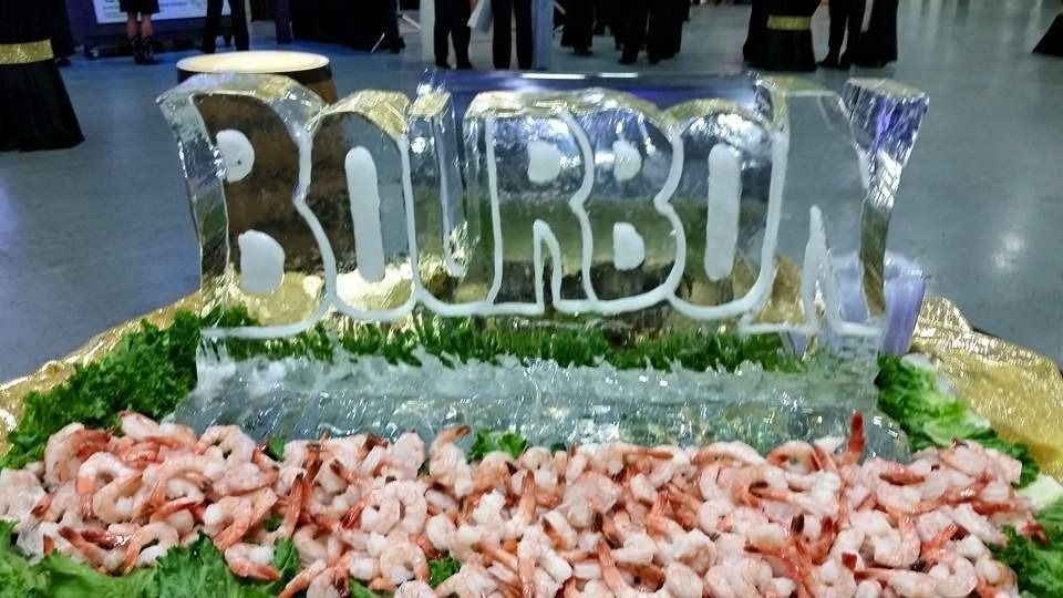 Bubbling ice sculpture with shrimp on a buffet table at an event