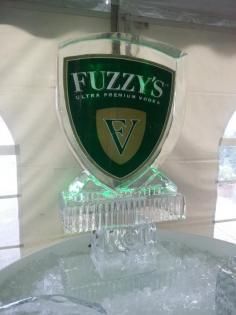 Fuzzy’s Ultra Premium Vodka shield sign on a clear pedestal with green backlighting