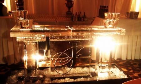Elegant mirrored table centerpiece with candles and warm glowing lights in a banquet setting