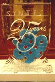 Glass plaque with blue and gold “24 years” design and the word “SYNT...” at the top