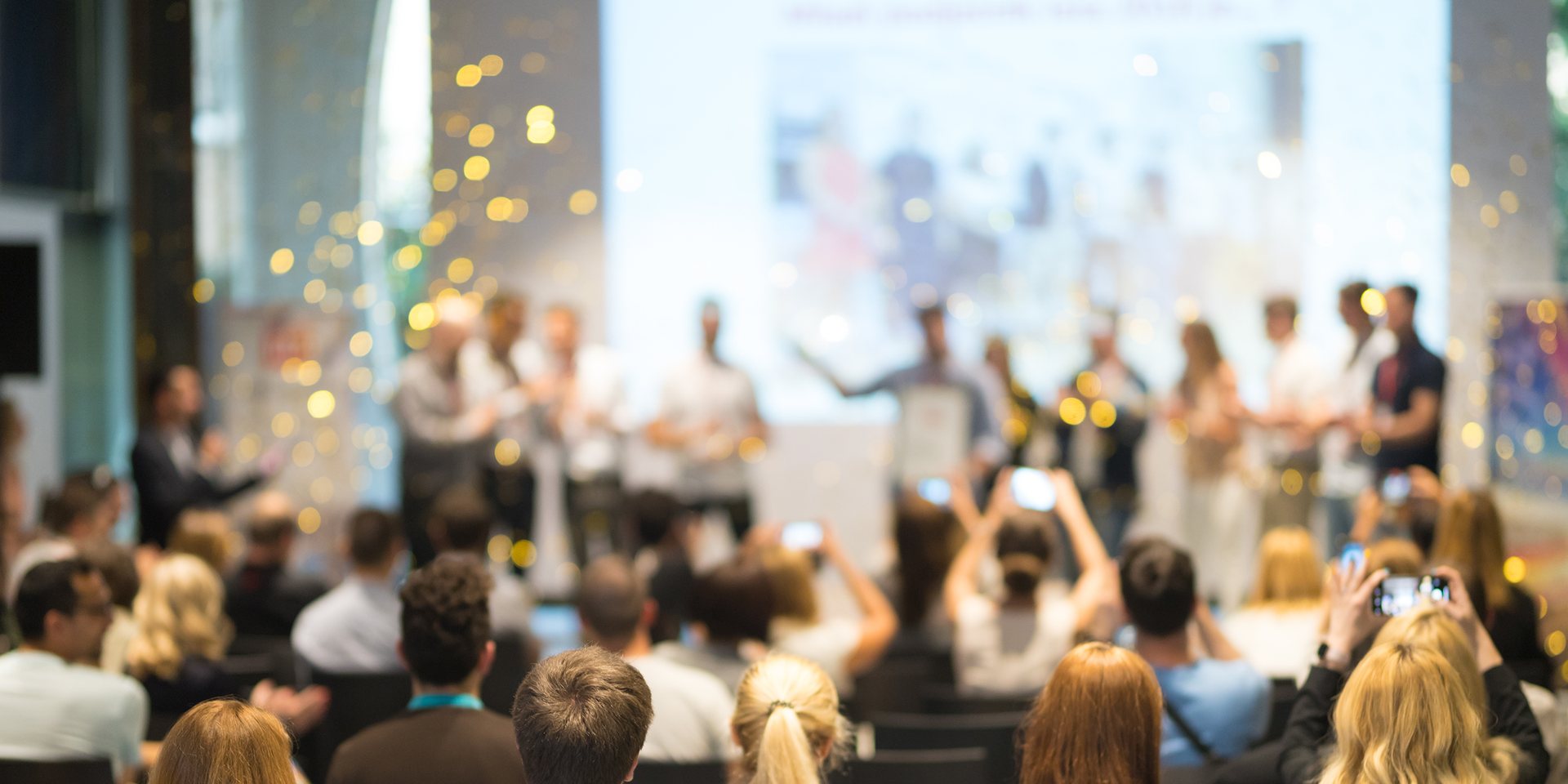 A crowd celebrate at an award ceremony