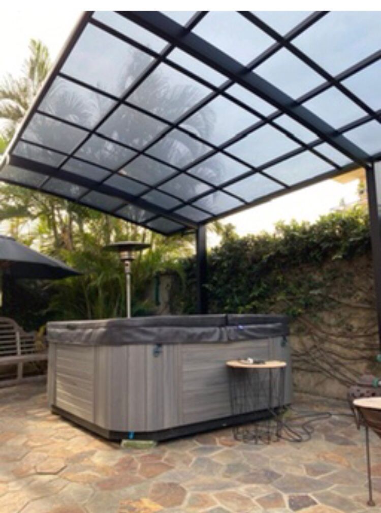 Un bain à remous sous un auvent sur une terrasse