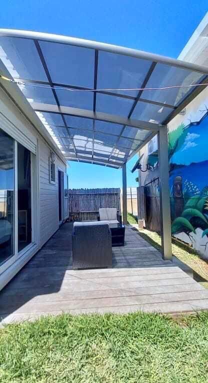 Un patio avec un auvent au-dessus et un tableau sur le mur.