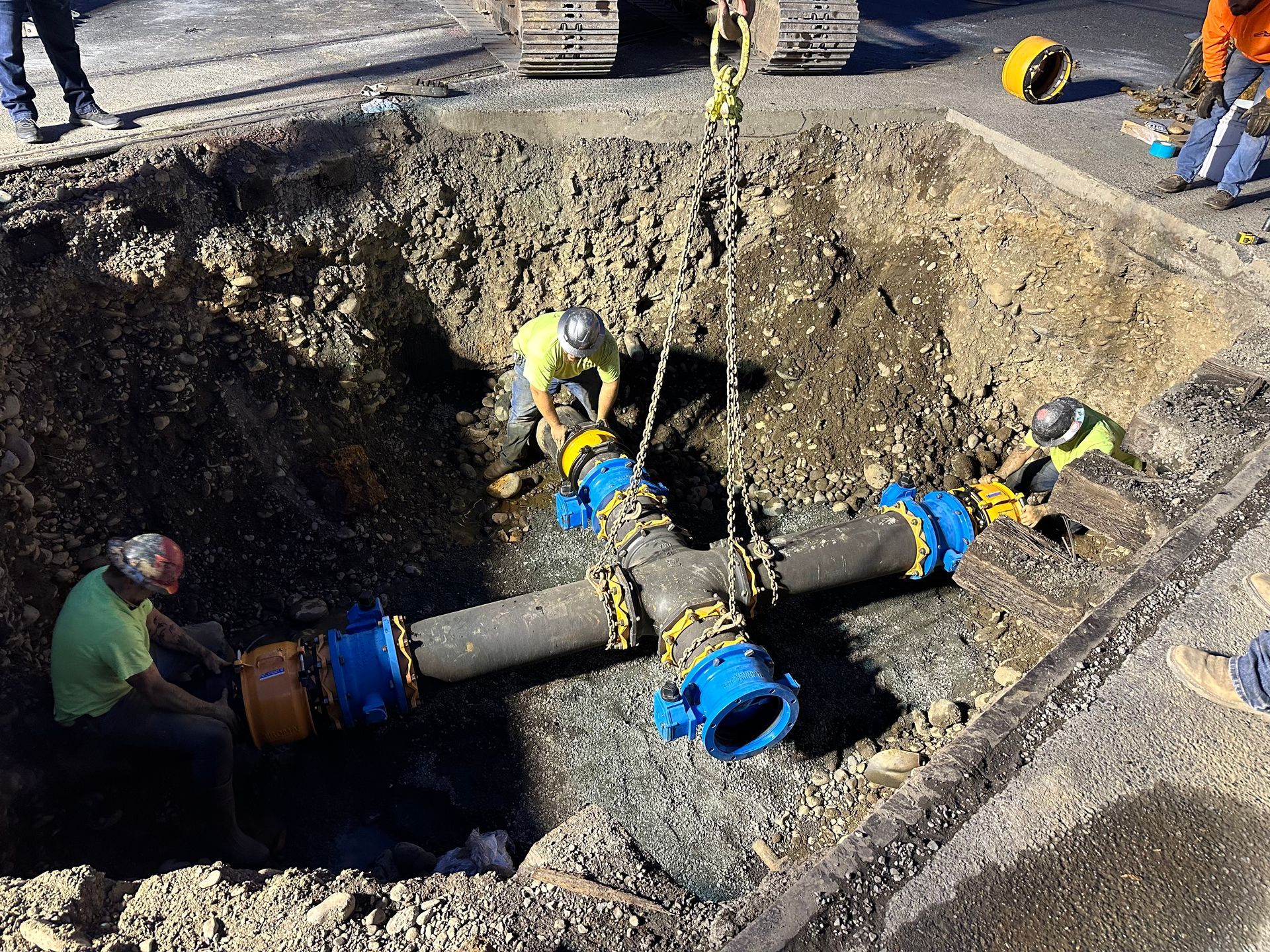 Snowplow clearing snow from a driveway at night. Dark truck with a red and white plow, with snow-covered setting.