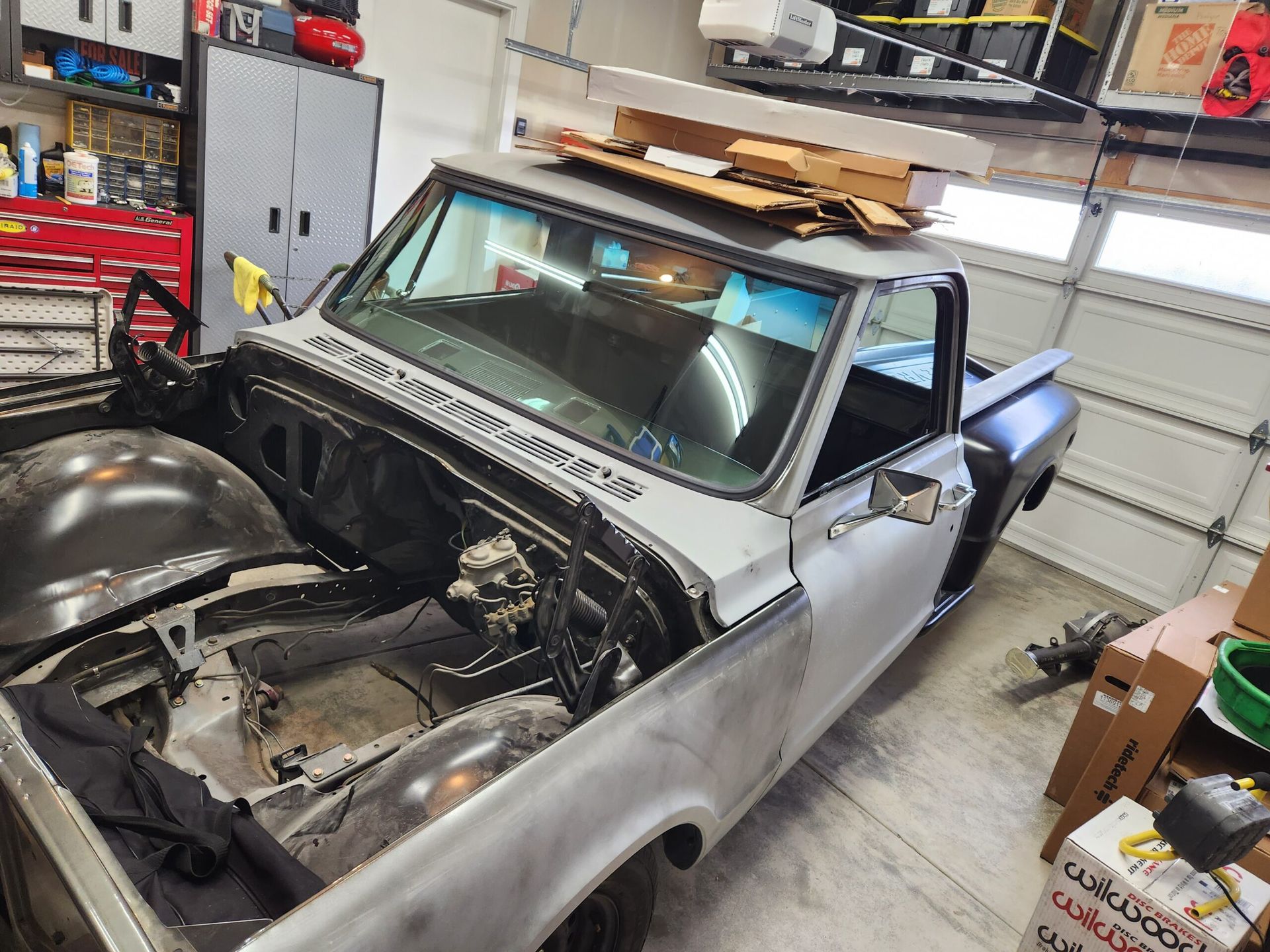 A Pickup Truck Is Sitting in a Garage With the Hood Open - Renton, WA - Good Dog Auto Glass