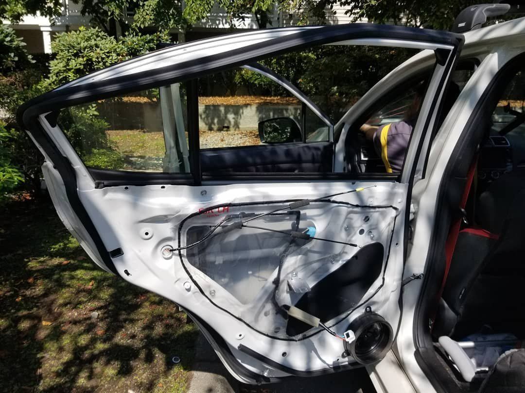 A White Car With the Door Open Is Sitting in the Grass - Renton, WA - Good Dog Auto Glass