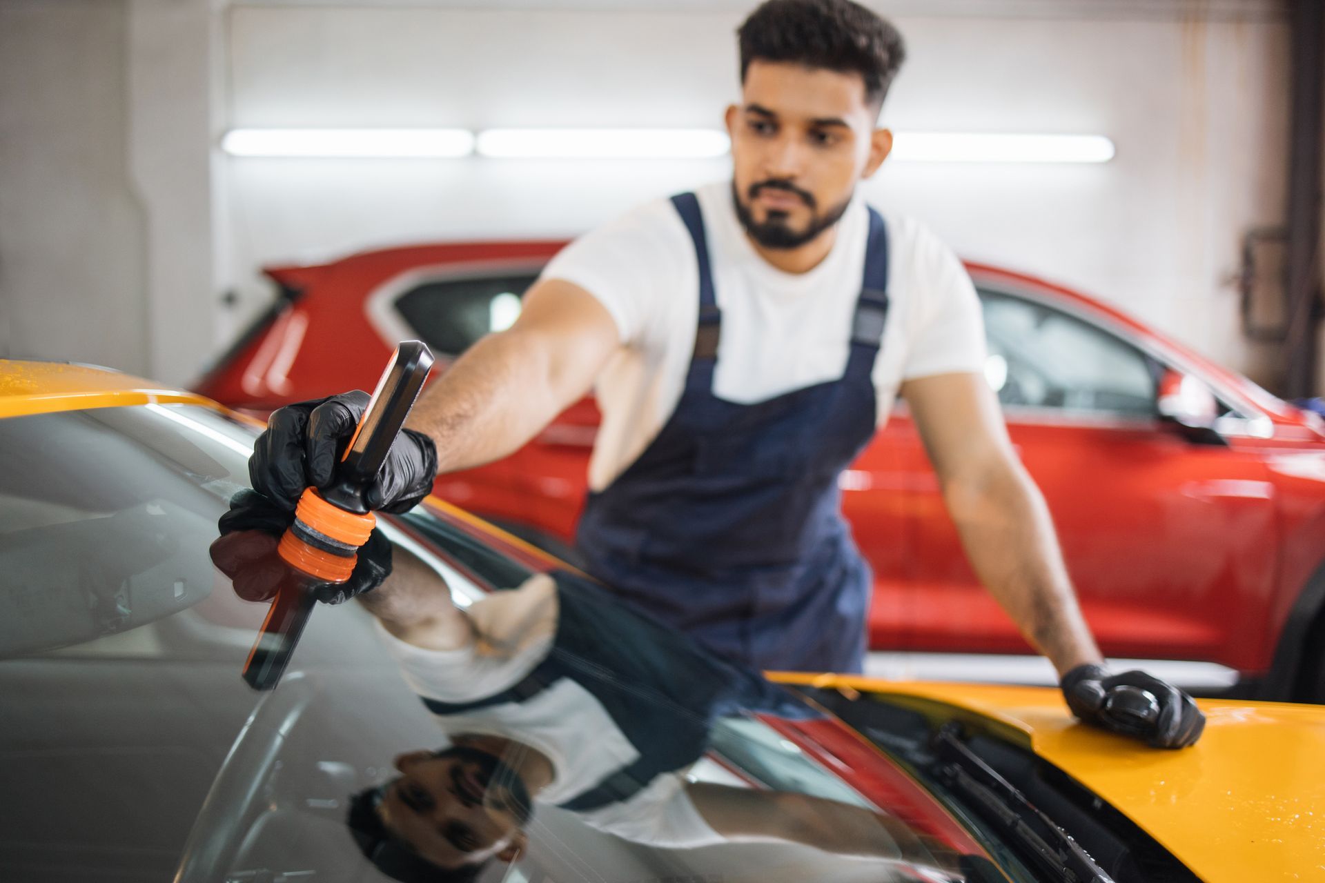 Male bearded worker on a professional car repair service. Male bearded worker on a professional car repair service.