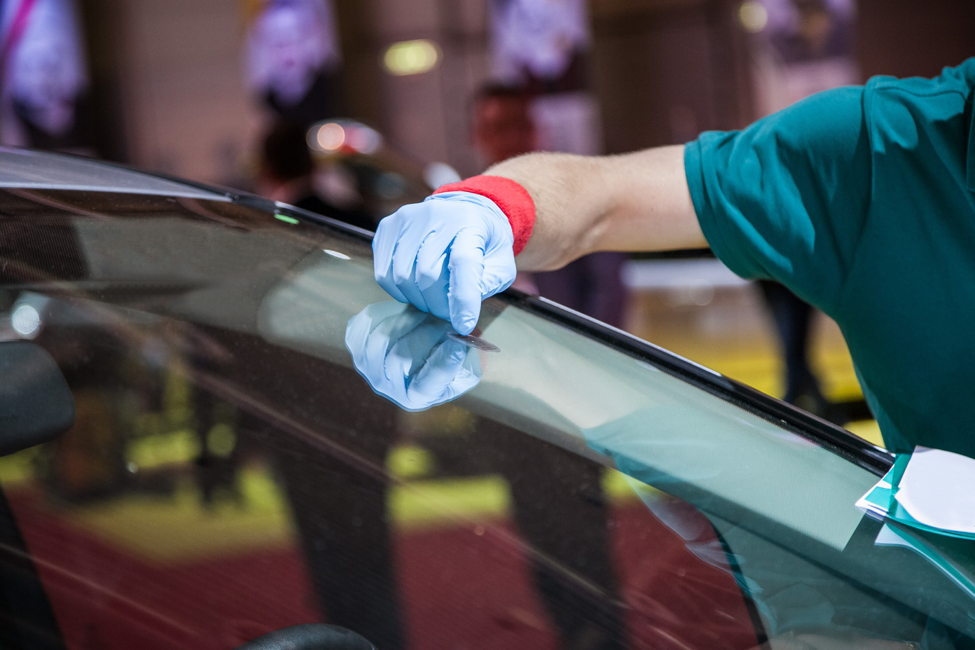 Luxury windshield repair process showing precision glass work on upscale vehicle.