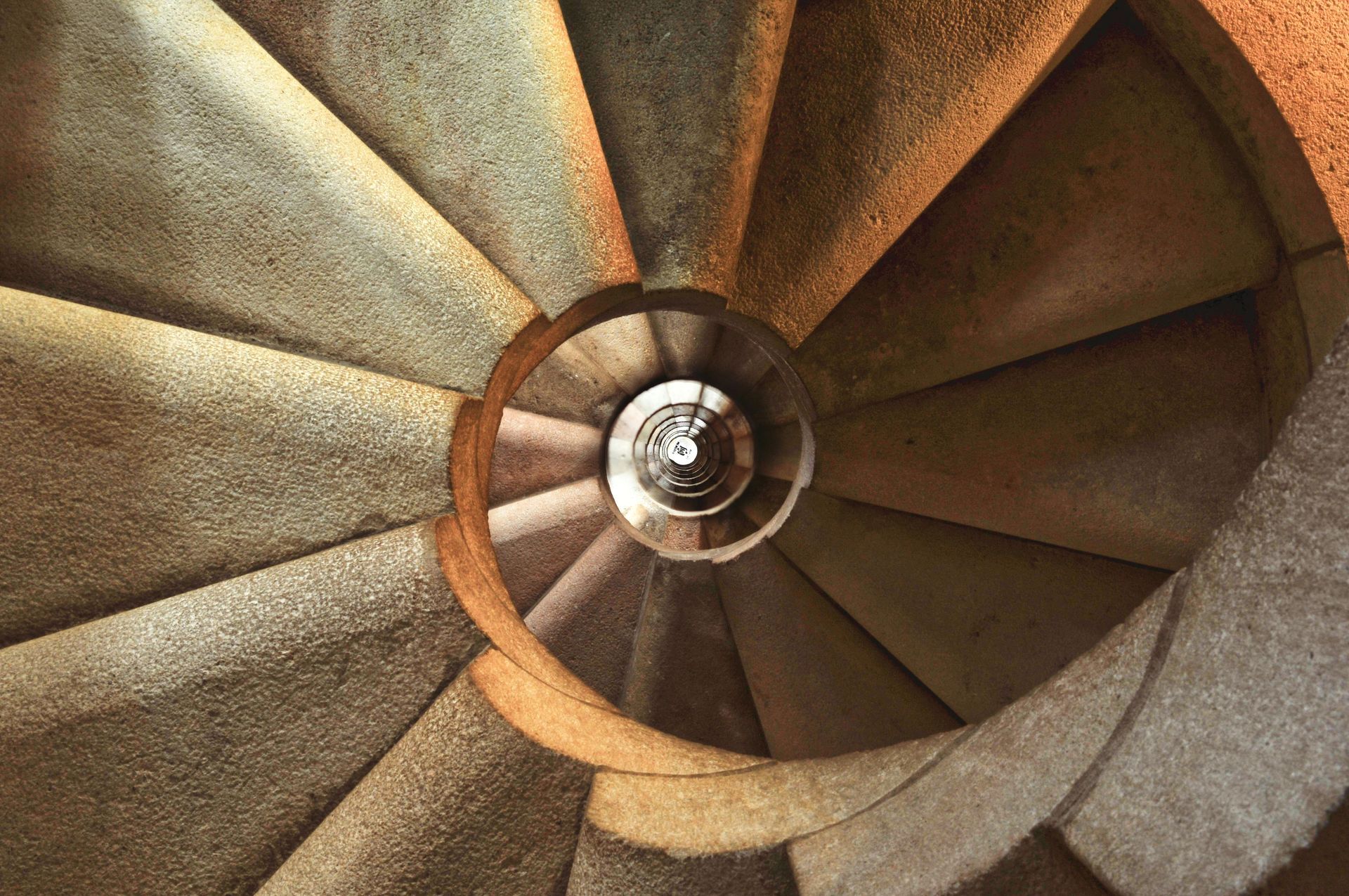 A close up of a spiral staircase going up and down.