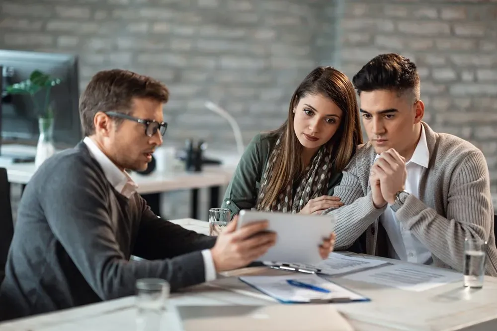 Discussing insurance policy to young couple