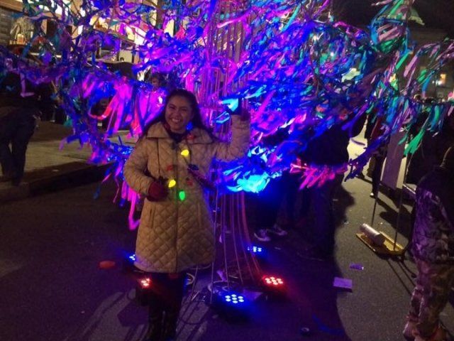 Bright lights surrounding woman in downtown Raleigh