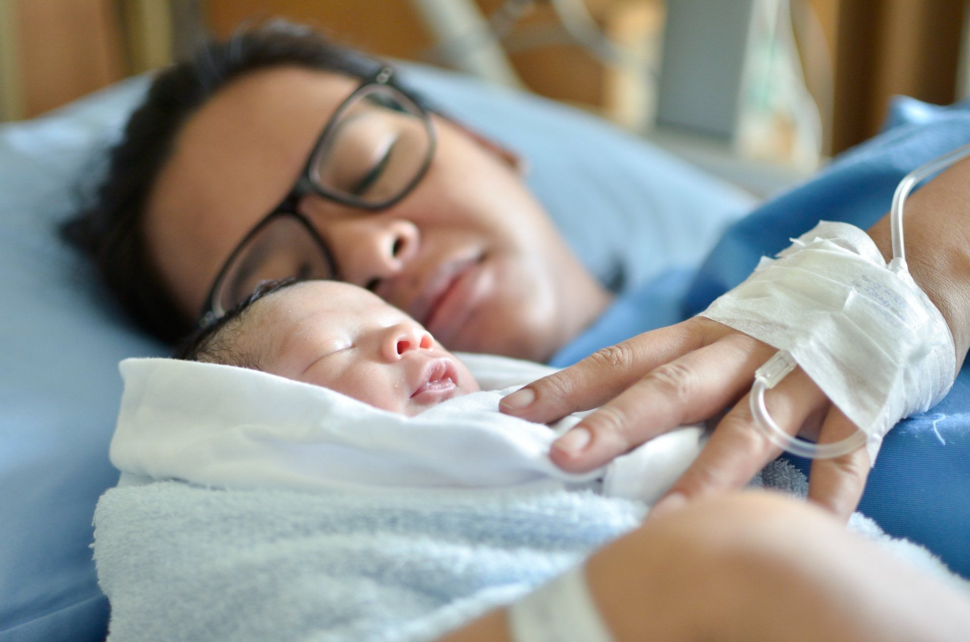new mom holding baby in hospital