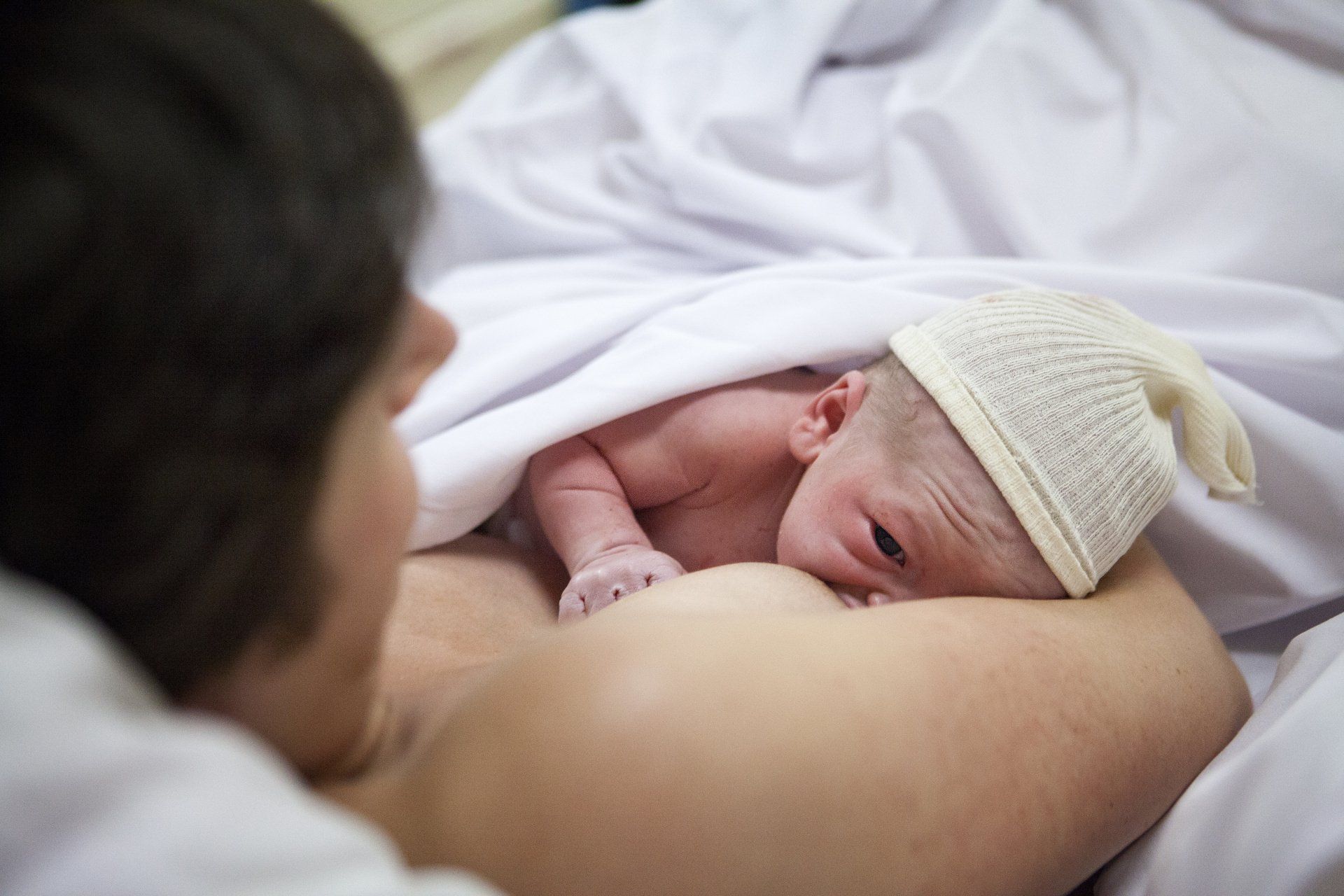 mom breastfeeding newborn