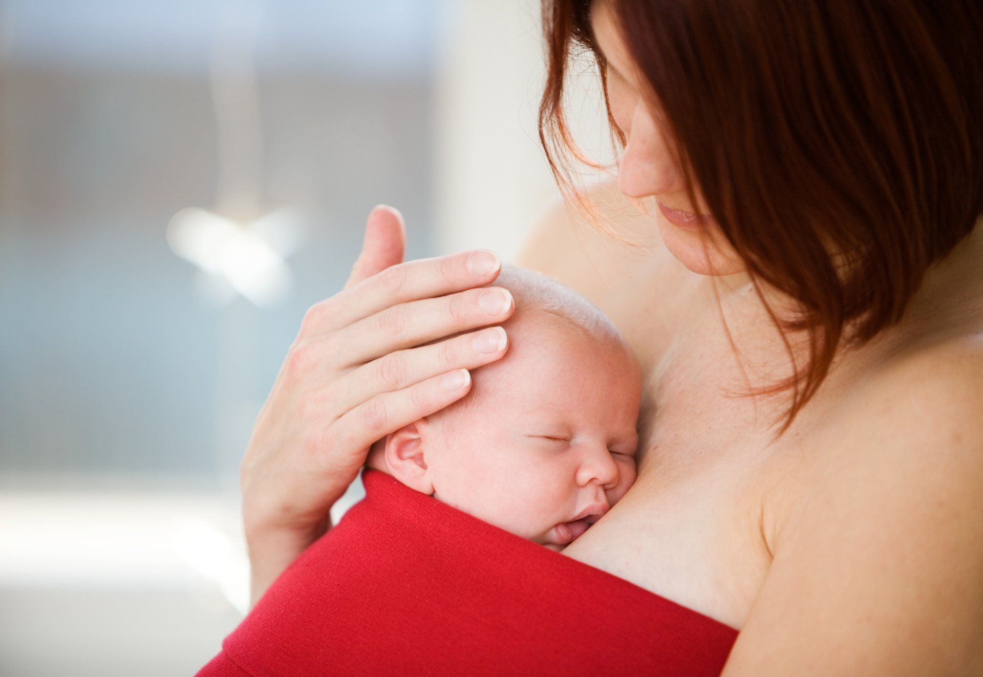 mom holding baby on chest