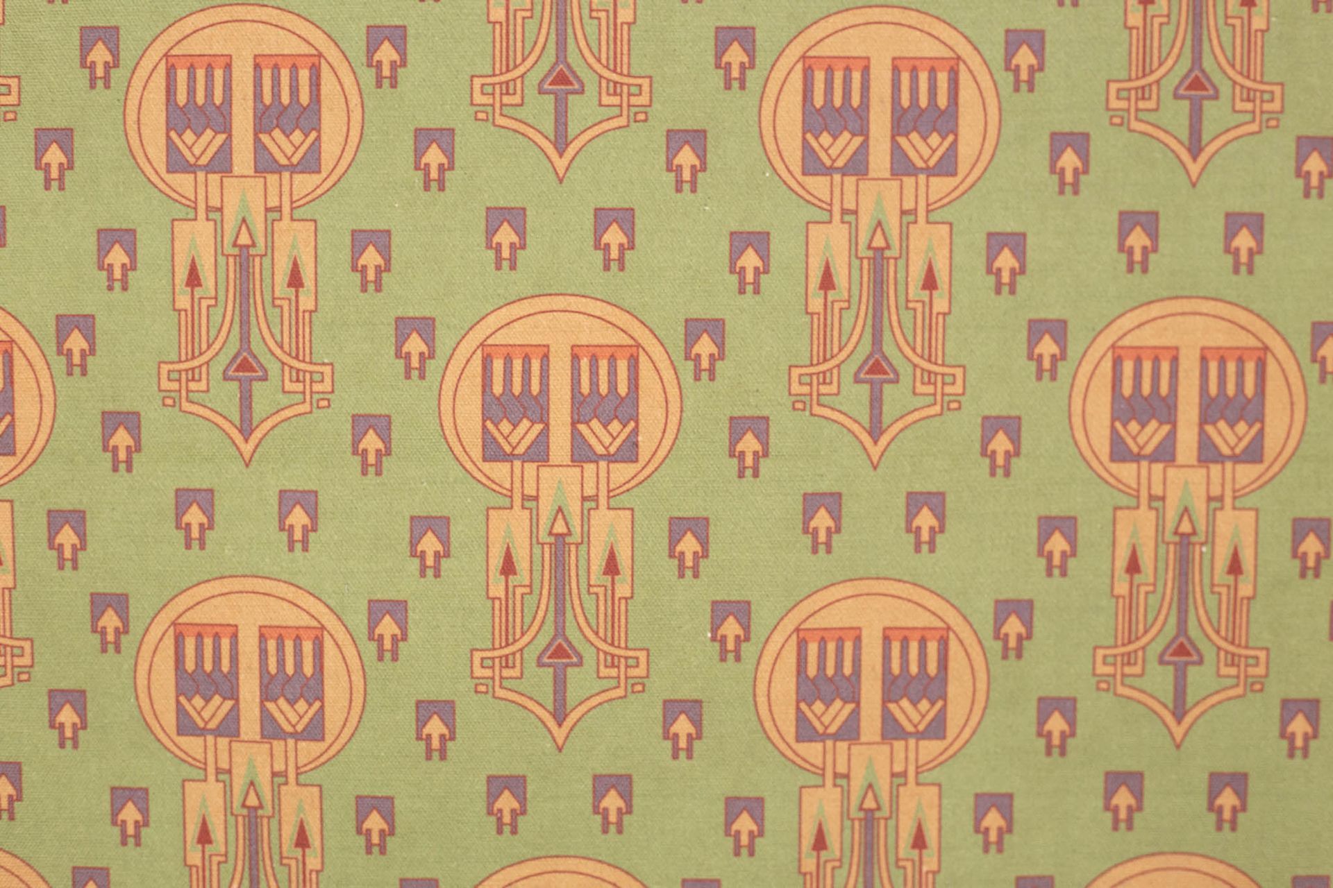 A close up of a green curtain with arrows on it