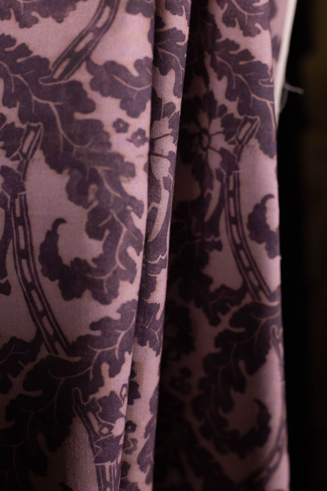 A close up of a purple curtain with a horseshoe pattern