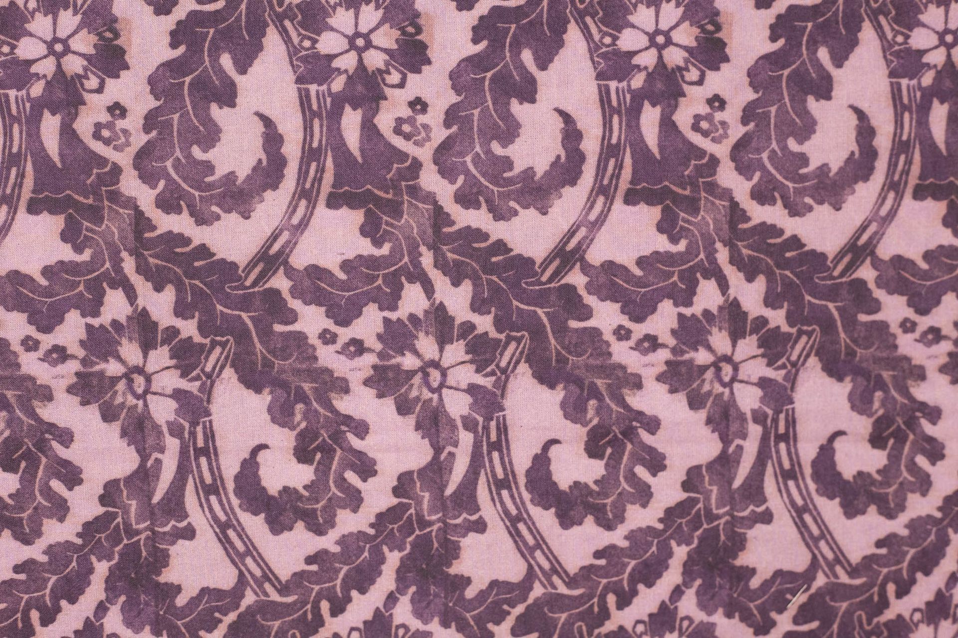 A close up of a purple curtain with a horseshoe pattern