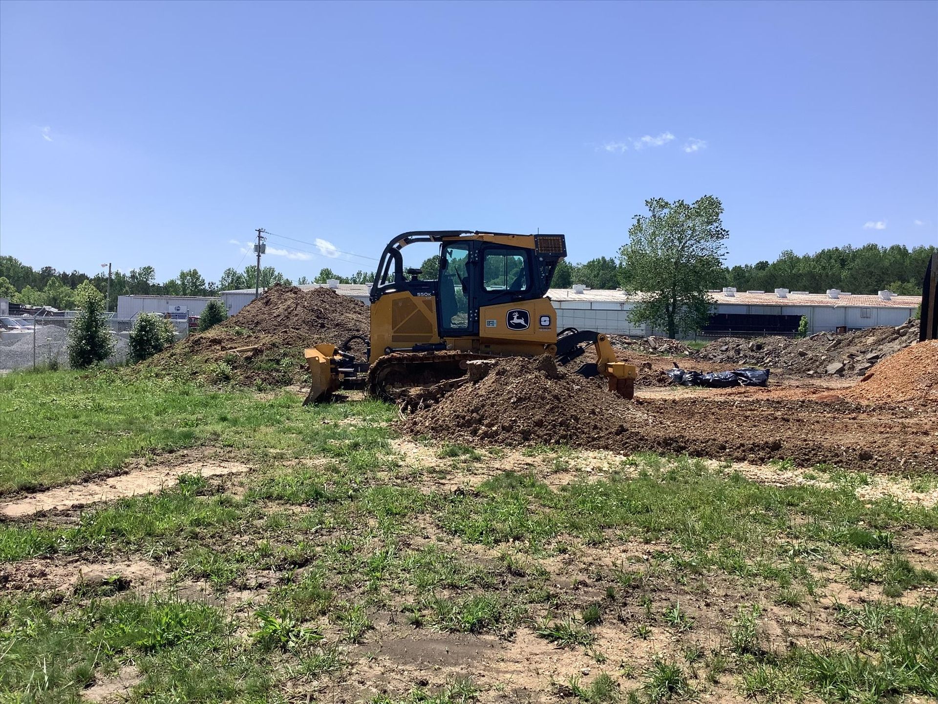A bulldozer is moving dirt in a field.