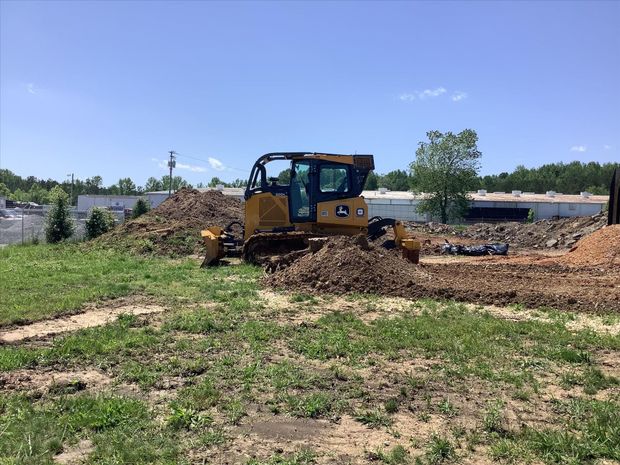 A bulldozer is moving dirt in a field.