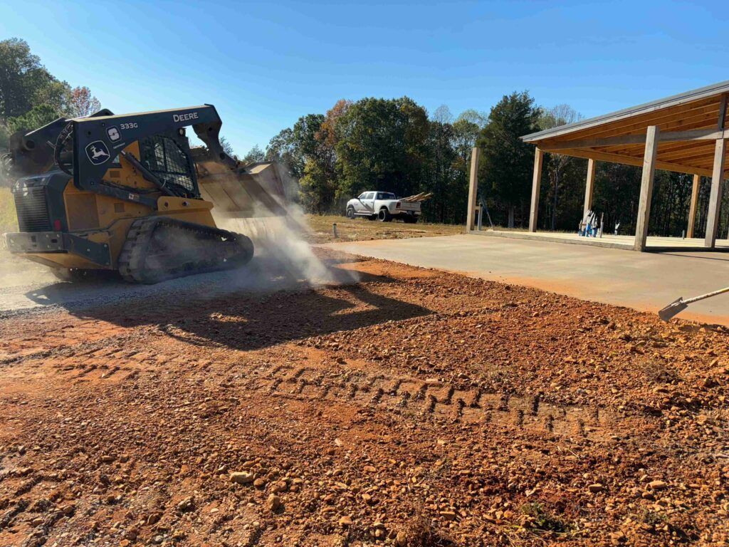 A bulldozer is spraying water on a dirt road.