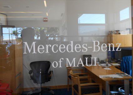 Mercedes-Benz of Maui glass wall featuring the logo