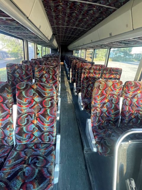 The inside of an empty bus with colorful seats.