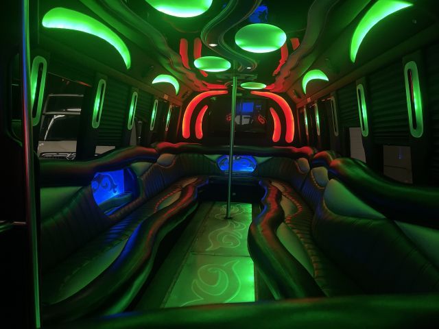 The inside of a limousine with green and red lights.