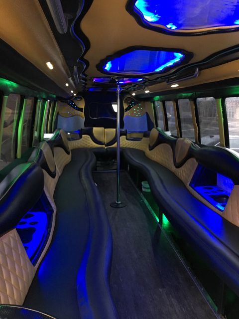 The inside of a limousine with blue lights on the ceiling