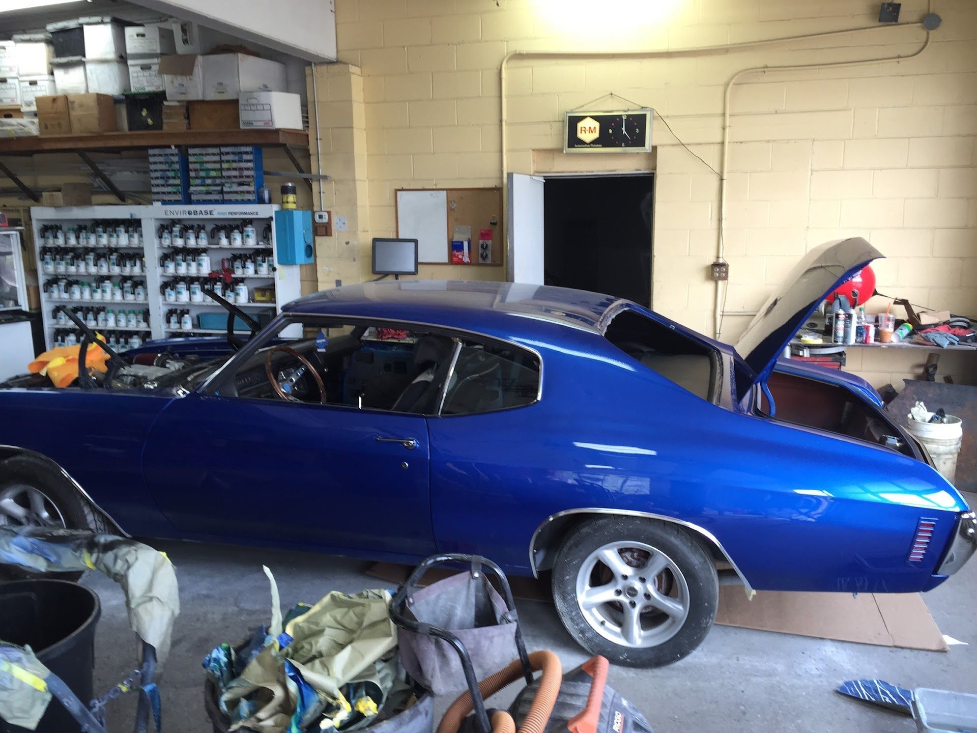 Blue classic car with open hood in a garage. | Rose Brothers Garage
