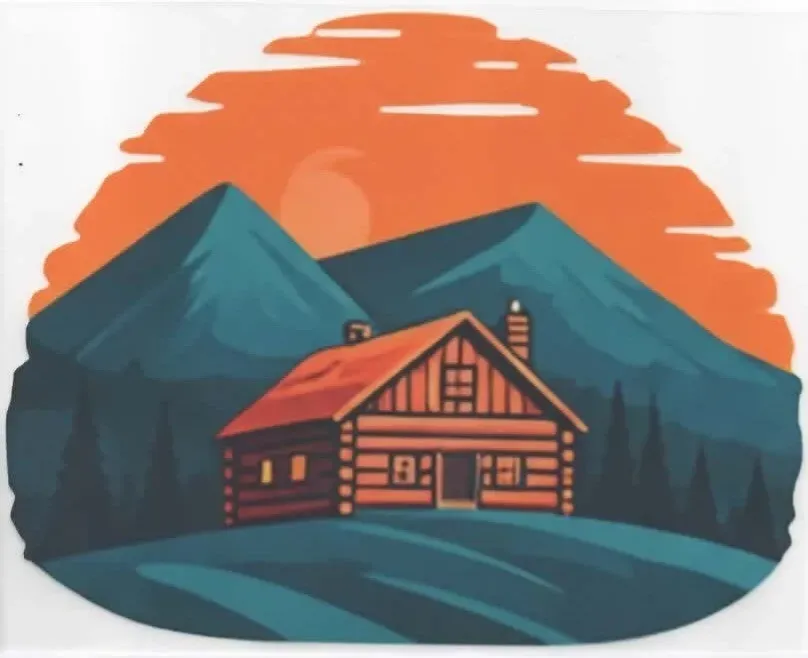 Cabin in mountains at sunset with orange sky.