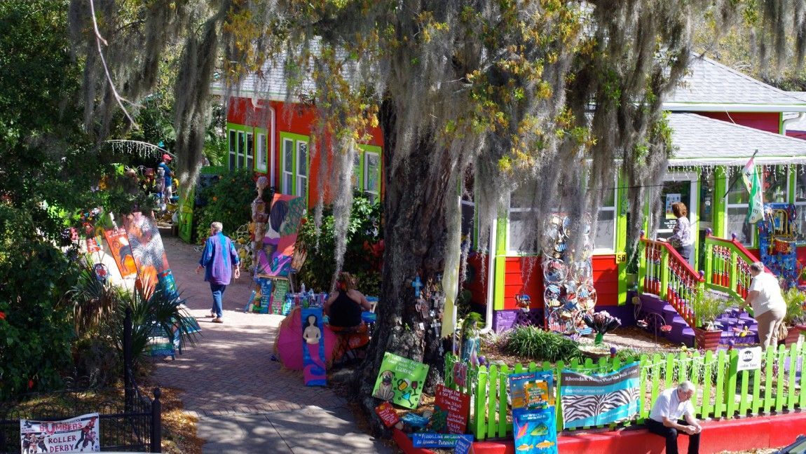 A group of people are walking down a path in a park.